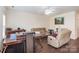 Spacious living room features modern floors, a ceiling fan and lots of natural light at 13612 Singleleaf Ln, Charlotte, NC 28278