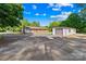 Backyard with an oversized driveway leading to a large detached garage/workshop at 1408 Delview Rd, Cherryville, NC 28021