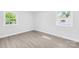 Bedroom featuring a bright, airy feel with two windows and gray wood-look floors at 1408 Delview Rd, Cherryville, NC 28021