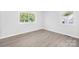 A bright bedroom with large windows offering great light and attractive gray wood-look floors at 1408 Delview Rd, Cherryville, NC 28021