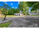 Long driveway leading to a detached garage, basketball hoop, and landscaped yard at 1408 Delview Rd, Cherryville, NC 28021