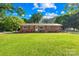 Charming brick home with a lush front lawn, garden beds, and a bright, sunny day at 1408 Delview Rd, Cherryville, NC 28021