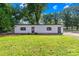 Detached garage with two entrances and a small garden bed out front on a sunny day at 1408 Delview Rd, Cherryville, NC 28021