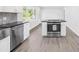 Modern kitchen with stainless steel dishwasher and range with an island and sleek countertops at 1408 Delview Rd, Cherryville, NC 28021