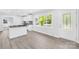 Open-concept kitchen with an eat-in island, stainless appliances, and a sun-filled window view at 1408 Delview Rd, Cherryville, NC 28021