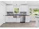 Updated kitchen featuring stainless steel appliances, a farmhouse sink, and marble backsplash at 1408 Delview Rd, Cherryville, NC 28021