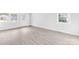 Bright living room featuring large windows for natural light and gray wood-look floors at 1408 Delview Rd, Cherryville, NC 28021