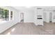 Bright, open-concept living room featuring gray wood-look floors and a modern color palette at 1408 Delview Rd, Cherryville, NC 28021
