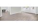 Bright living room with laminate floors, freshly painted grey brick wall and new windows at 1408 Delview Rd, Cherryville, NC 28021