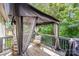 Charming back deck with a canopy, comfortable seating, and serene wooded views at 14512 Brotherly Ln, Charlotte, NC 28278