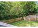 Lush backyard showcasing a wooden fence, mature trees, and a private, green space at 14512 Brotherly Ln, Charlotte, NC 28278