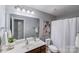 Clean bathroom showcasing a large mirror, vanity, and white shower curtain at 14512 Brotherly Ln, Charlotte, NC 28278