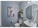Charming half bath featuring updated fixtures, floating shelves, and stylish decor at 14512 Brotherly Ln, Charlotte, NC 28278