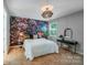 Stylish bedroom with a statement wall, modern lighting, and comfortable furnishings, blending aesthetics and comfort at 14512 Brotherly Ln, Charlotte, NC 28278