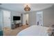 Cozy bedroom with a mounted TV, closet, and attached bathroom, offering functionality and comfort at 14512 Brotherly Ln, Charlotte, NC 28278