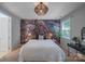 Well-appointed bedroom with unique light fixture and statement wall creating a focal point in the room at 14512 Brotherly Ln, Charlotte, NC 28278