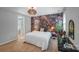 Comfortable bedroom with floral wallpaper, vanity table, and pendant lighting enhancing the room's appeal at 14512 Brotherly Ln, Charlotte, NC 28278