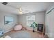 Inviting bedroom with a ceiling fan, comfortable beanbag chair, and chalkboard art at 14512 Brotherly Ln, Charlotte, NC 28278
