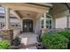Inviting covered entry with decorative pillars, stone accents, and double doors that create a grand entrance at 14512 Brotherly Ln, Charlotte, NC 28278