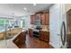 Modern kitchen boasting wooden cabinets, stainless steel appliances, and an island with a sink at 14512 Brotherly Ln, Charlotte, NC 28278
