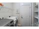 Well-equipped laundry room with ample shelving and modern washer and dryer units at 14512 Brotherly Ln, Charlotte, NC 28278