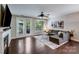 Spacious living room featuring hardwood floors, gas fireplace, and access to the outdoor patio at 14512 Brotherly Ln, Charlotte, NC 28278