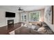 Bright living room with a fireplace, hardwood floors, and sliding door access to the deck at 14512 Brotherly Ln, Charlotte, NC 28278