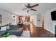 Open-concept living space with hardwood floors connecting the living room, dining area and kitchen at 14512 Brotherly Ln, Charlotte, NC 28278