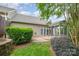View of the backyard featuring a screened in porch and patio with manicured landscaping at 14822 Rocky Top Dr, Huntersville, NC 28078