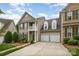 View of the two story home with a two-car garage, second story balcony and manicured lawn at 14822 Rocky Top Dr, Huntersville, NC 28078