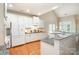 Bright kitchen featuring white cabinets, granite countertops, hardwood floors, and modern appliances at 14822 Rocky Top Dr, Huntersville, NC 28078