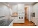 Bright kitchen features white cabinets, granite countertops, and modern appliances, with great lighting at 14822 Rocky Top Dr, Huntersville, NC 28078