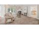 Inviting living room with a cozy fireplace and large windows for natural light at 14822 Rocky Top Dr, Huntersville, NC 28078