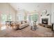 Inviting living room with a cozy fireplace, and large windows providing great natural light at 14822 Rocky Top Dr, Huntersville, NC 28078
