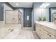 Well-lit main bathroom with a glass-enclosed shower and separate soaking tub at 14822 Rocky Top Dr, Huntersville, NC 28078