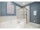 Spacious main bathroom with a large soaking tub and glass-enclosed shower at 14822 Rocky Top Dr, Huntersville, NC 28078