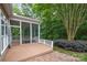 View of screened porch that offers a tranquil outdoor space bordered by lush greenery and brick at 14822 Rocky Top Dr, Huntersville, NC 28078