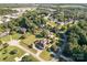 Aerial view of brick home on large lot in wooded neighborhood with mature trees and landscaping at 150 Northchase Dr, Concord, NC 28027