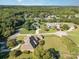 Aerial view of brick home on large lot in wooded neighborhood with mature trees and landscaping at 150 Northchase Dr, Concord, NC 28027