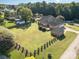 Aerial view of brick home showing large landscaped lot with privacy fence and mature landscaping at 150 Northchase Dr, Concord, NC 28027