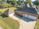 Aerial view of brick home showing attached three car garage and detached garage with large back yard at 150 Northchase Dr, Concord, NC 28027