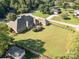 Aerial view of brick home showing large deck and detached brick garage on large landscaped lot at 150 Northchase Dr, Concord, NC 28027