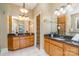 Well-lit bathroom features dual sinks with dark countertops and tile floors at 150 Northchase Dr, Concord, NC 28027