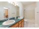 Well lit bathroom featuring double sinks, green countertops, and a shower with a bathtub at 150 Northchase Dr, Concord, NC 28027