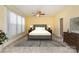 Staged bedroom features neutral carpet, trim, and walls and a ceiling fan with light fixture at 150 Northchase Dr, Concord, NC 28027