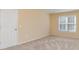 Cozy carpeted bedroom with a window letting in natural light and neutral wall color at 150 Northchase Dr, Concord, NC 28027