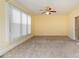 Bright bedroom features neutral carpet, trim, and walls and a ceiling fan with light fixture at 150 Northchase Dr, Concord, NC 28027