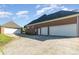 Exterior shot of a house with a three-car garage and spacious driveway and a detached garage at 150 Northchase Dr, Concord, NC 28027