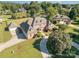 Expansive brick home showcasing meticulously manicured landscaping, mature trees, and a circular driveway at 150 Northchase Dr, Concord, NC 28027