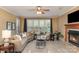 Cozy living room featuring a fireplace, comfortable seating, and a large window with natural light at 150 Northchase Dr, Concord, NC 28027